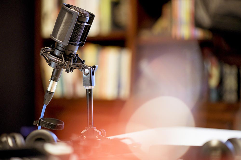 microphone studio surrounded by equipment lights with blurry backgrounds